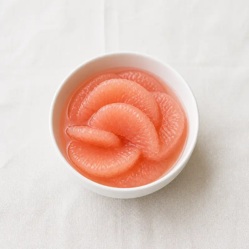 Canned Grapefruit, a nutrient-dense plant-based food, photographed on a plain linen surface