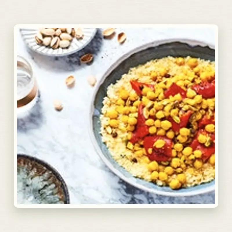 Chickpea and Roasted Red Pepper Pantry Tagine plated on an off-white linen surface